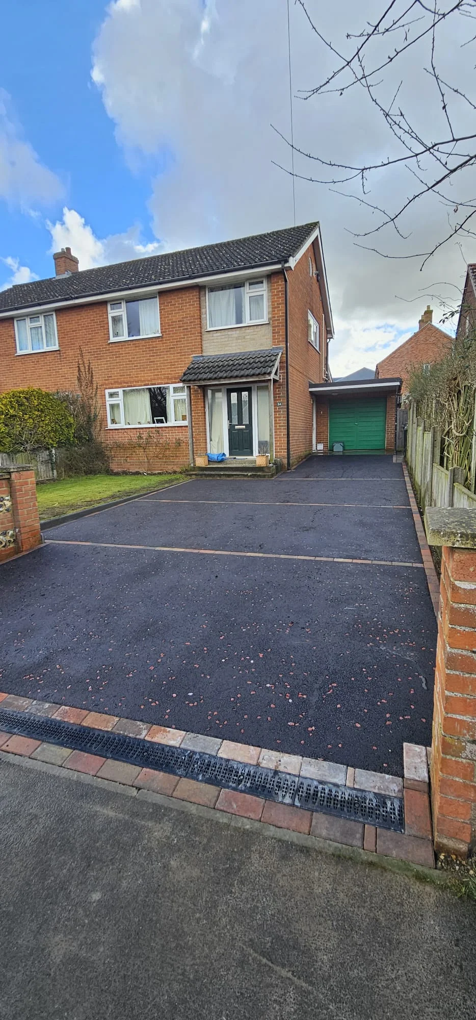 Tarmac driveway with red chippings and a red border
