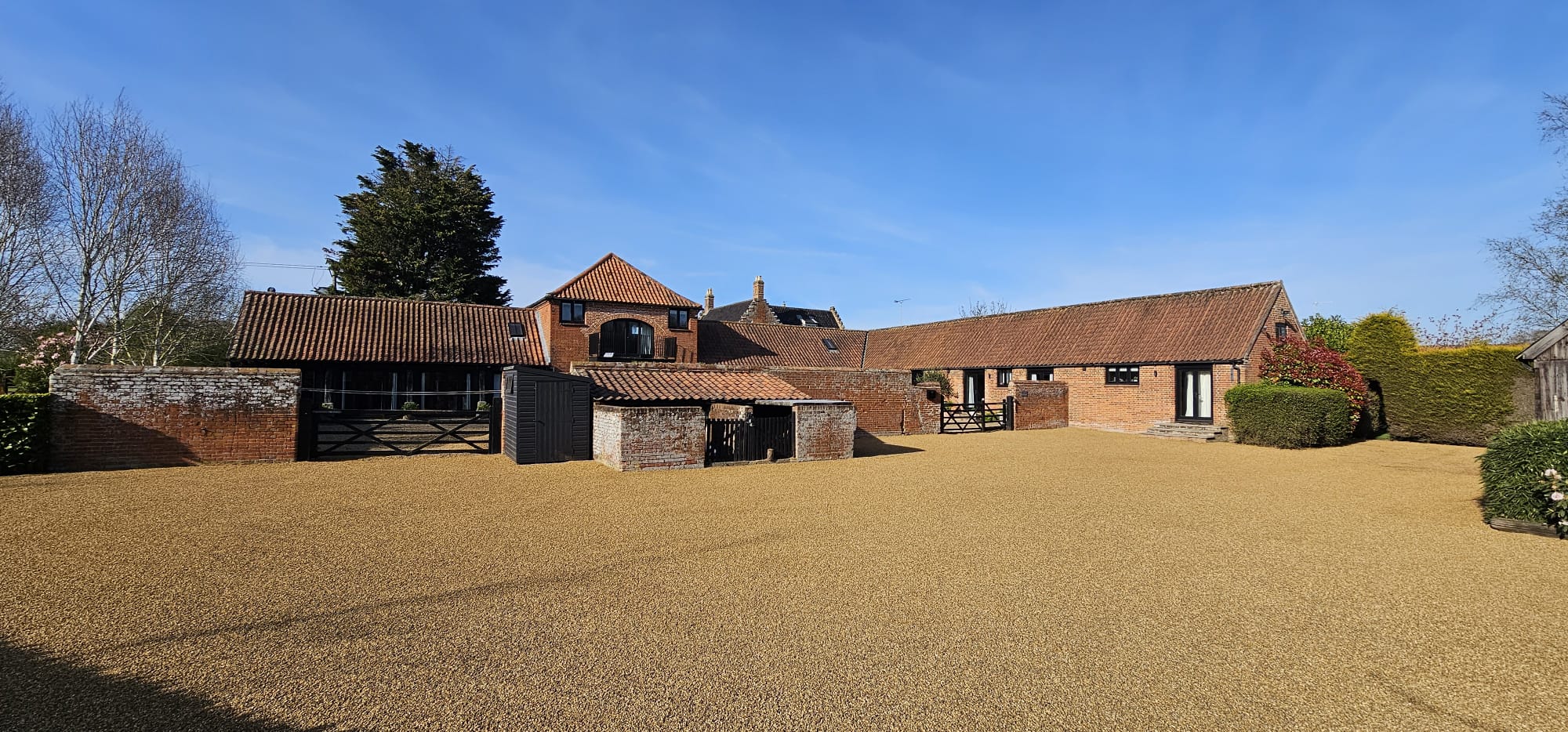 Tar and chip driveway in Foulsham, Norfolk — natural stone chipping finish by Precision Surfacing
